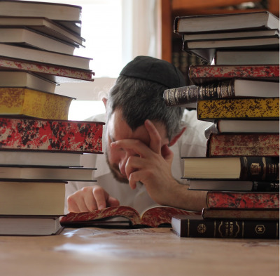 Photo of a Jewish man studying by Menachem Weinreb